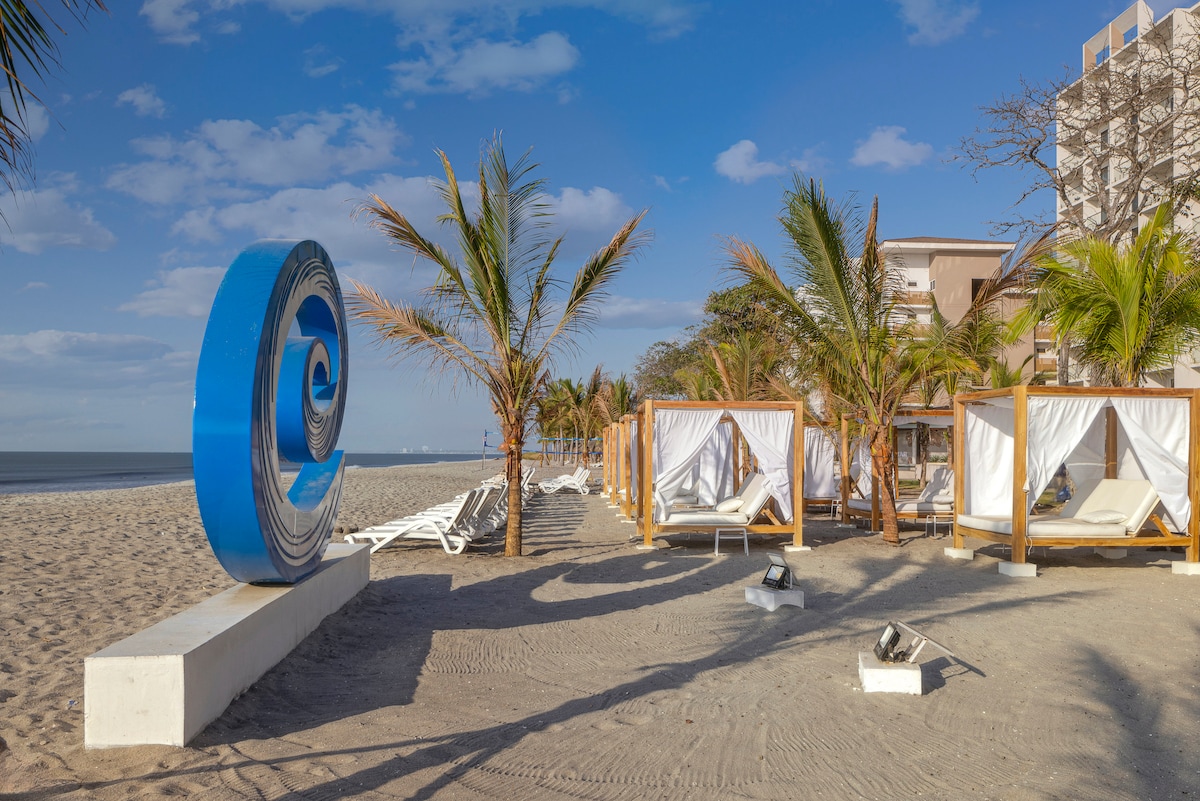 Beach cabanas and lounge area at Playa Caracol