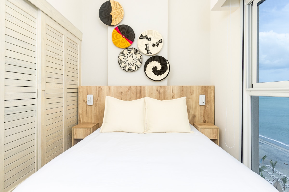 Bedroom with floor-to-ceiling window and ocean view in Penthouse 900-7