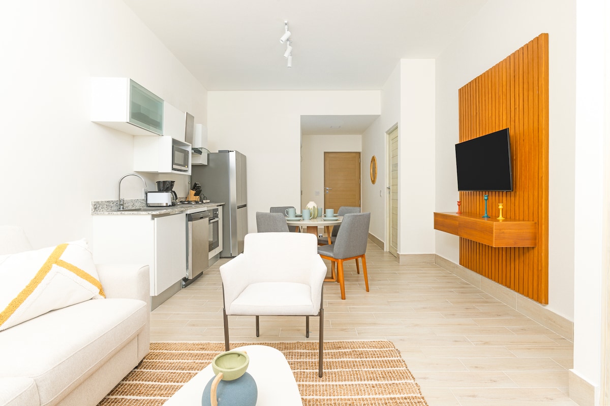 Open-concept living, dining and kitchen area in Penthouse 900-7
