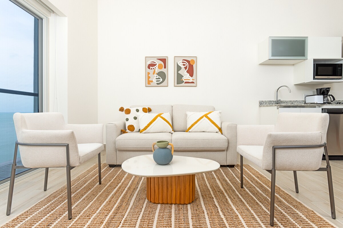 Living room seating area with sofa and armchairs in Penthouse 900-7