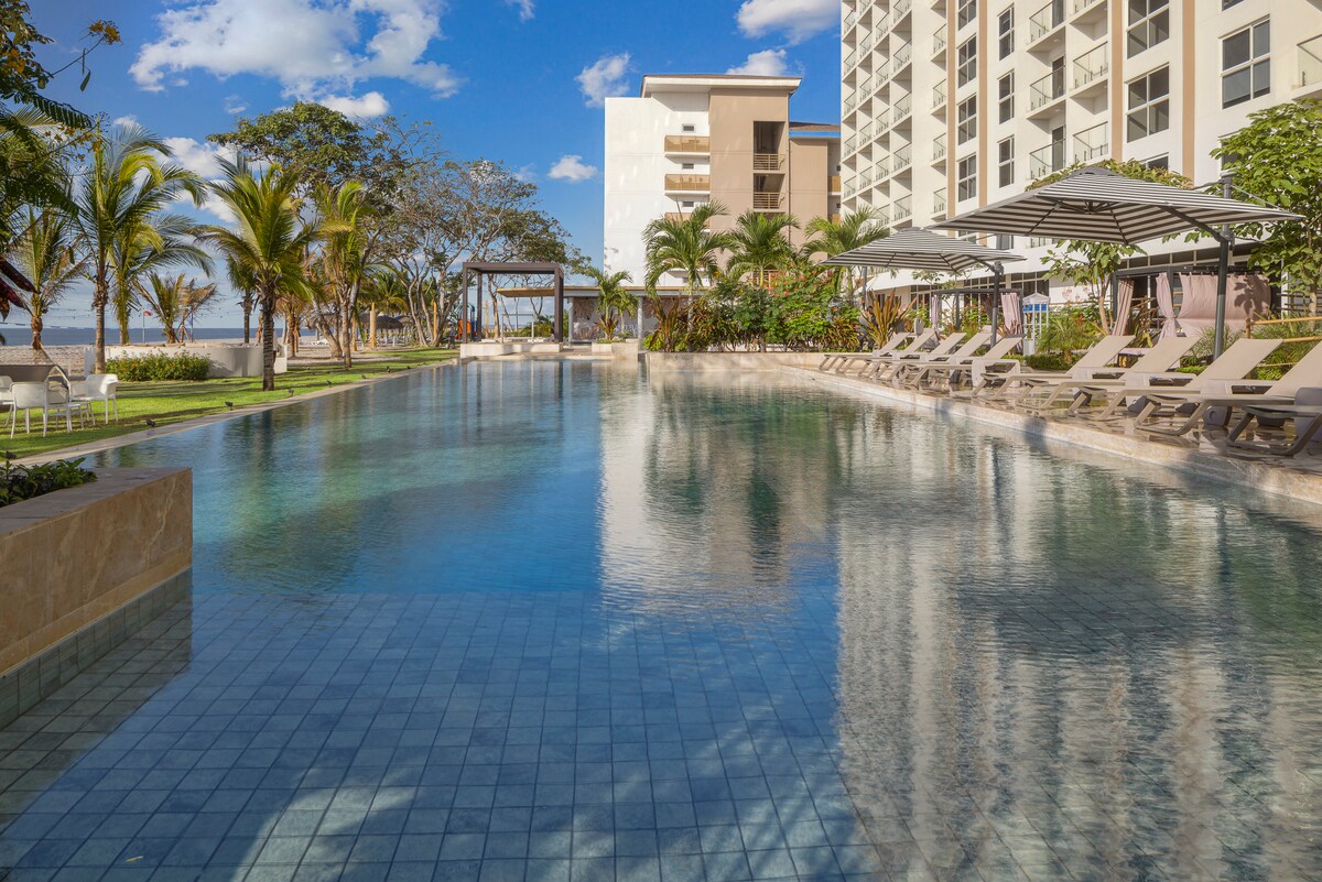 Pool deck with loungers and umbrellas at Playa Caracol