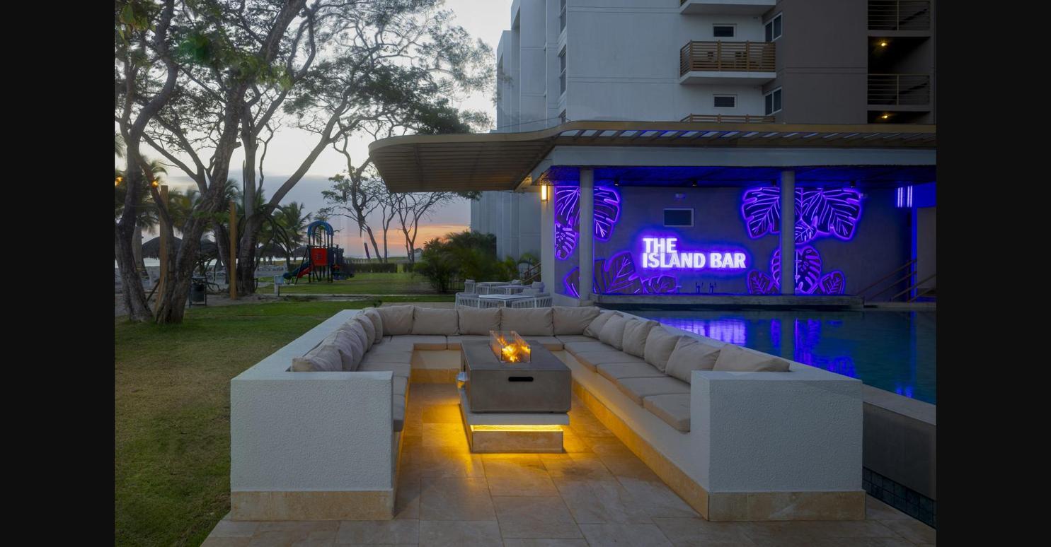 Beach lounge area at Playa Caracol at golden hour