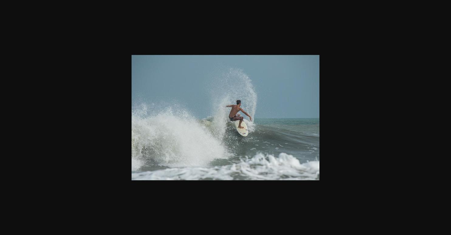 Surfer riding a wave at Playa Caracol, Panama